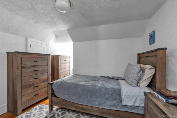 a bedroom with a bed and chair