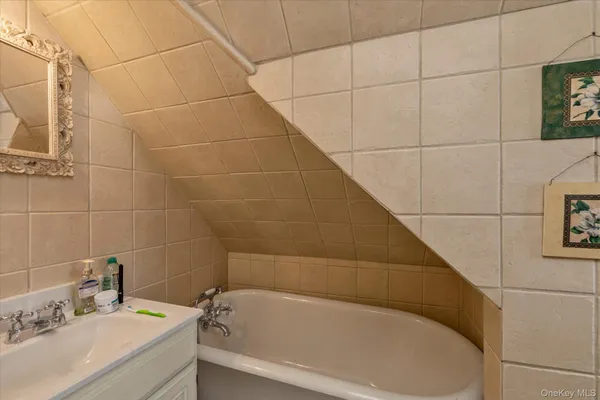 a bathroom with a bathtub and sink