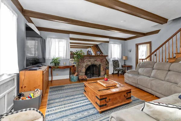 a living room with furniture a fireplace and a large window