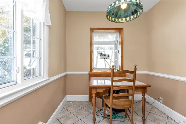 a view of a dining room with furniture and window