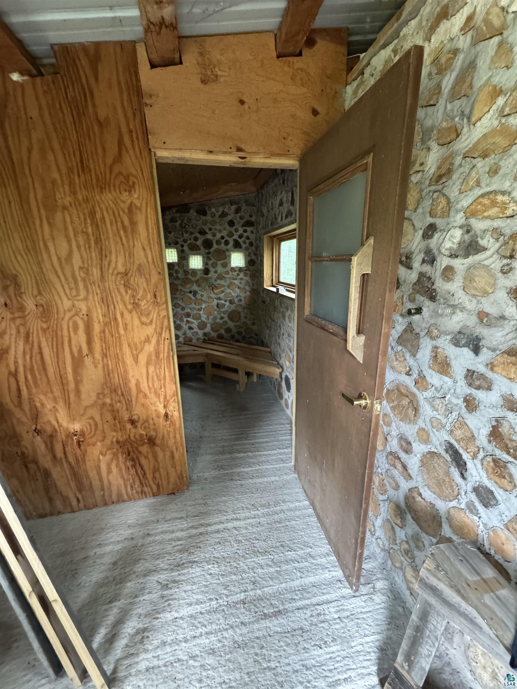 1745 Becks Road Maple, WI 54854 - Photo 40 of 46 Interior stone wall construction, changing room of sauna