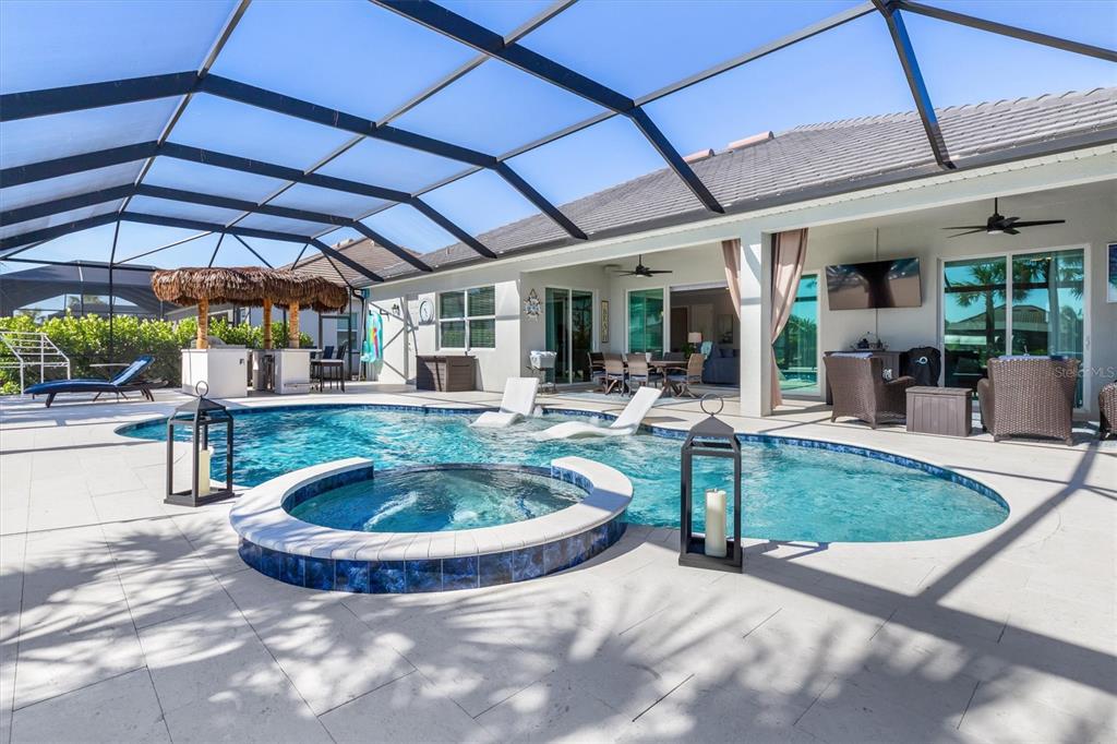 14564 Gaspar Loop Port Port Charlotte, FL 33981 - Photo 1 of 1 a view of a backyard with table and chairs under an umbrella