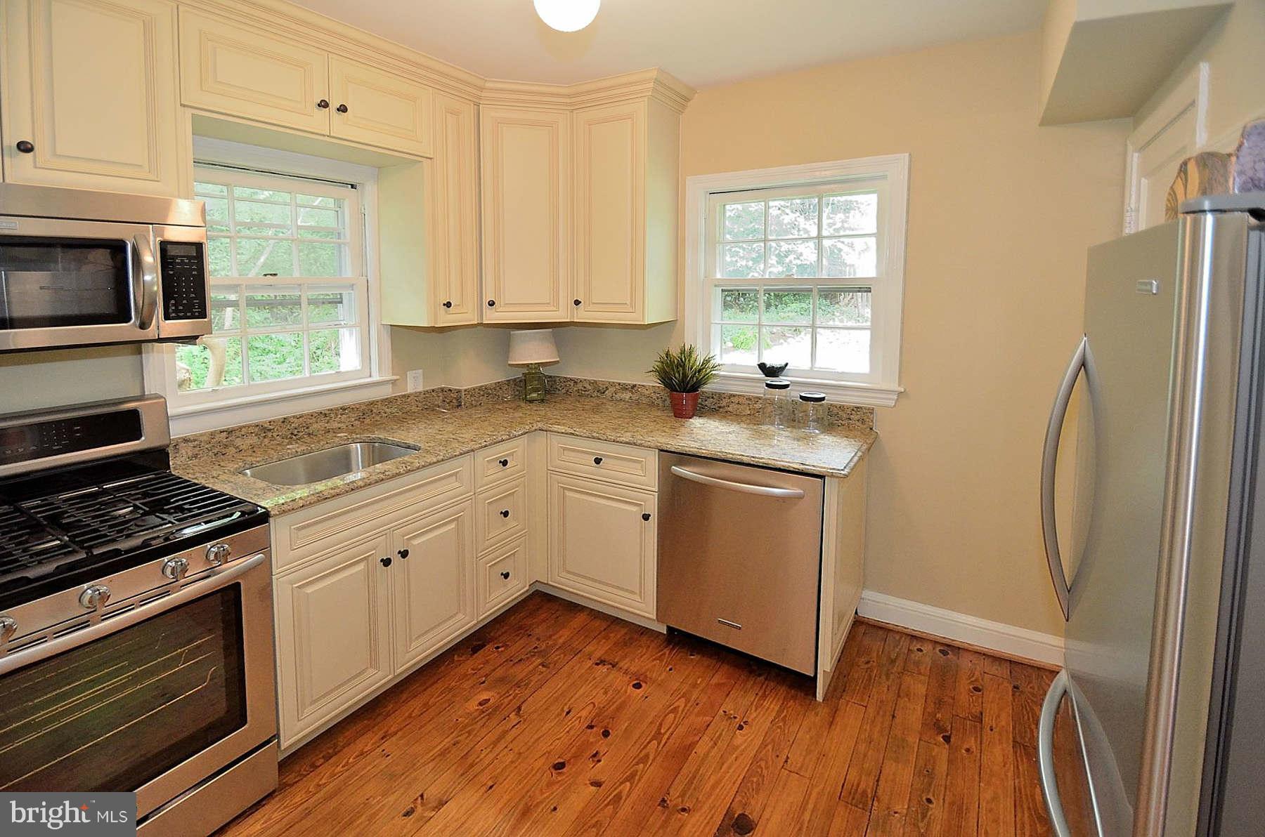 2423 Ridge Rd Drive Alexandria, VA 22302 - Photo 8 of 19 a kitchen with a sink wooden floor and stainless steel appliances
