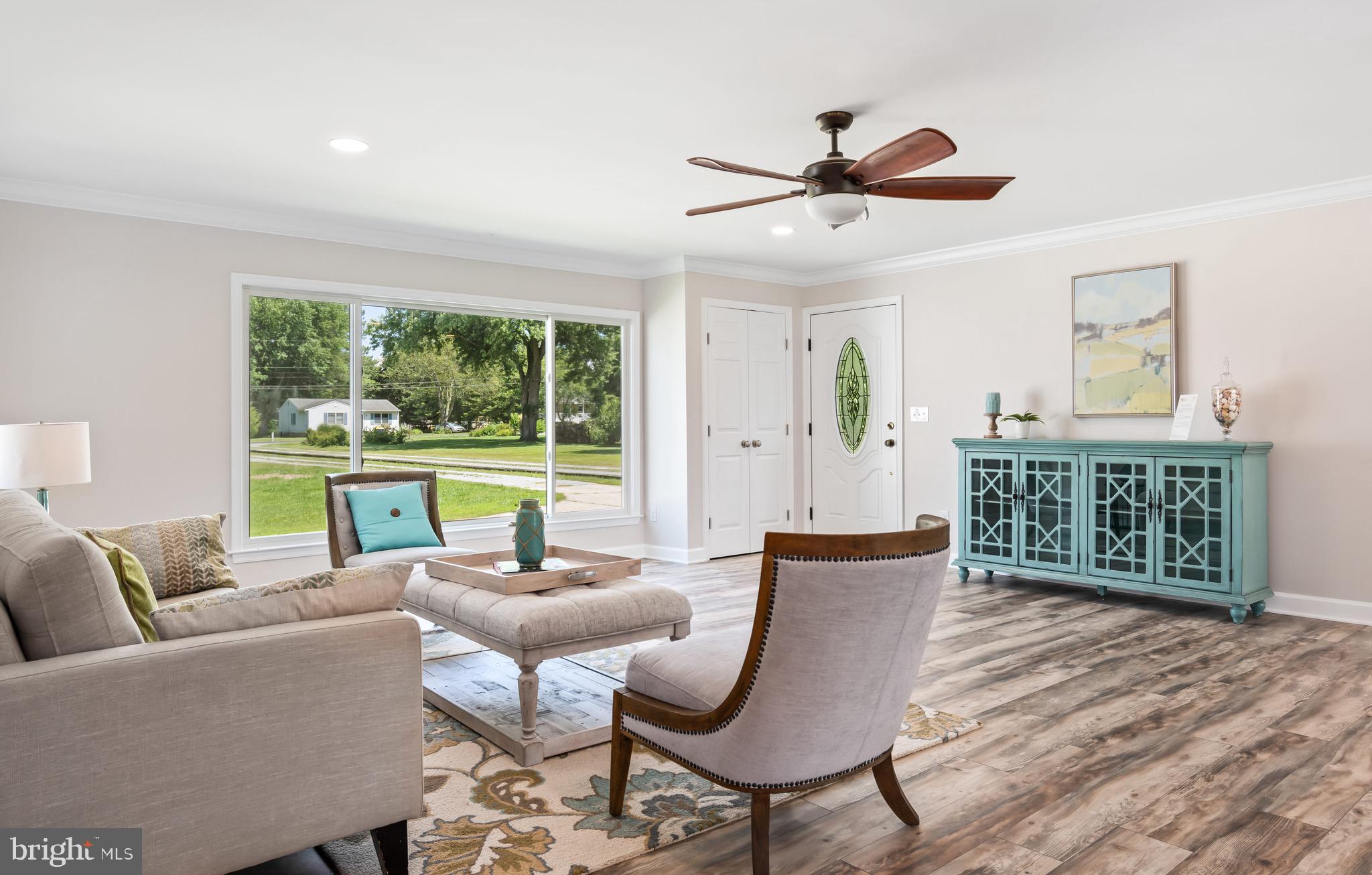 115 Parks Road Chester, MD 21619 - Photo 8 of 54 a living room with furniture and a floor to ceiling window