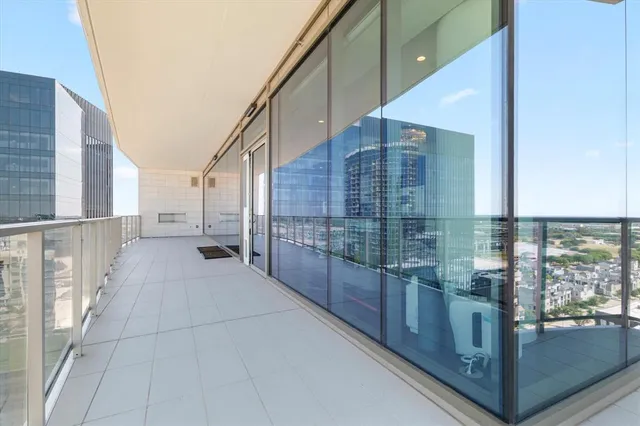 a lobby with furniture and lots of glass door