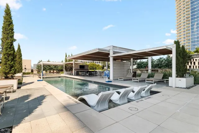 an aerial view of a house with a swimming pool and outdoor seating