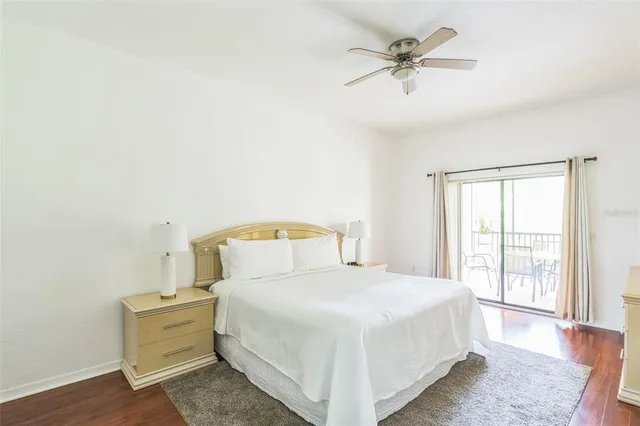 a bedroom with a bed and a ceiling fan