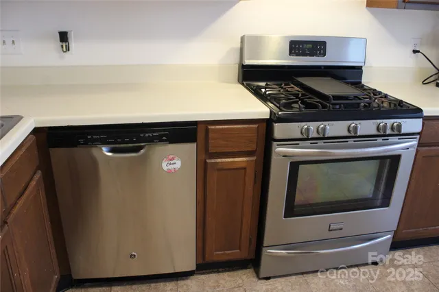 a kitchen with stainless steel appliances granite countertop a stove and a microwave