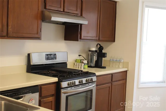 a kitchen with a stove and a refrigerator