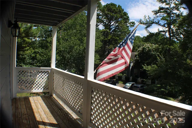 a view of an empty room with a ceiling fan and window