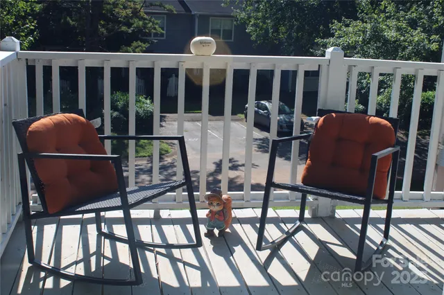 a view of a chairs and table in the roof deck