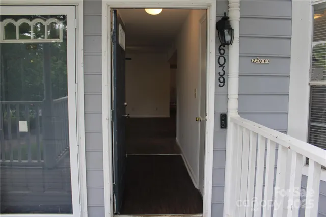 an empty room with windows and ceiling fan