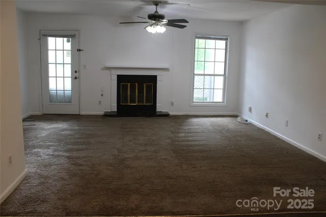 a view of a livingroom with a ceiling fan and window
