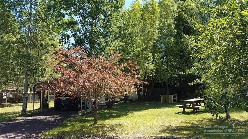 59720 Navajo Road Bend, OR 97702 - Photo 2 of 23 Several mature trees add peaceful sereni