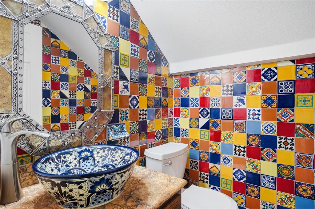 2133 Rustic Ridge Drive Keller, TX 76248 - Photo 16 of 40 Half bath featuring tile walls, vanity, and vaulted ceiling