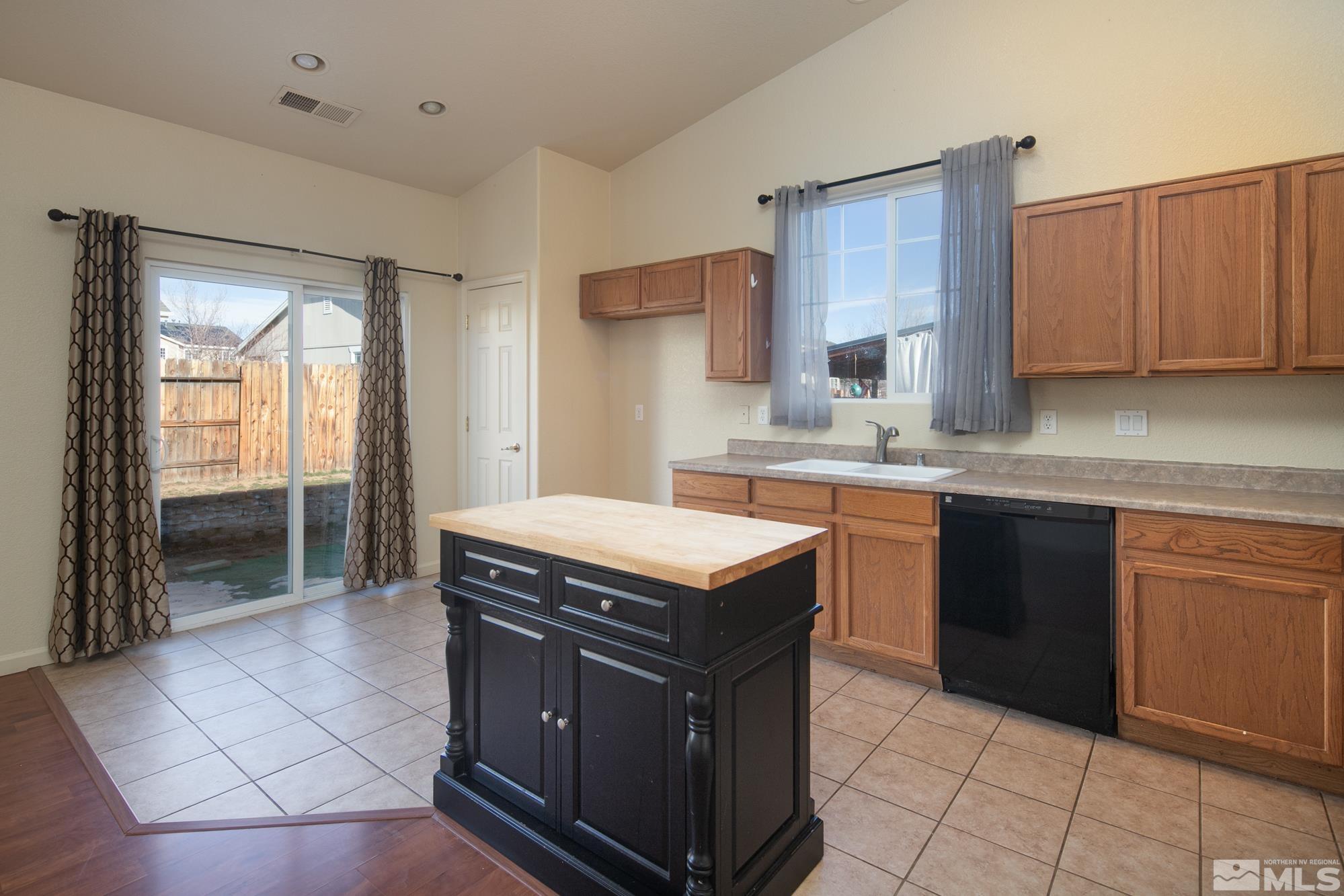 8987 Sorcha Street Reno, NV 89506 - Photo 4 of 29 a kitchen with a stove sink and cabinets