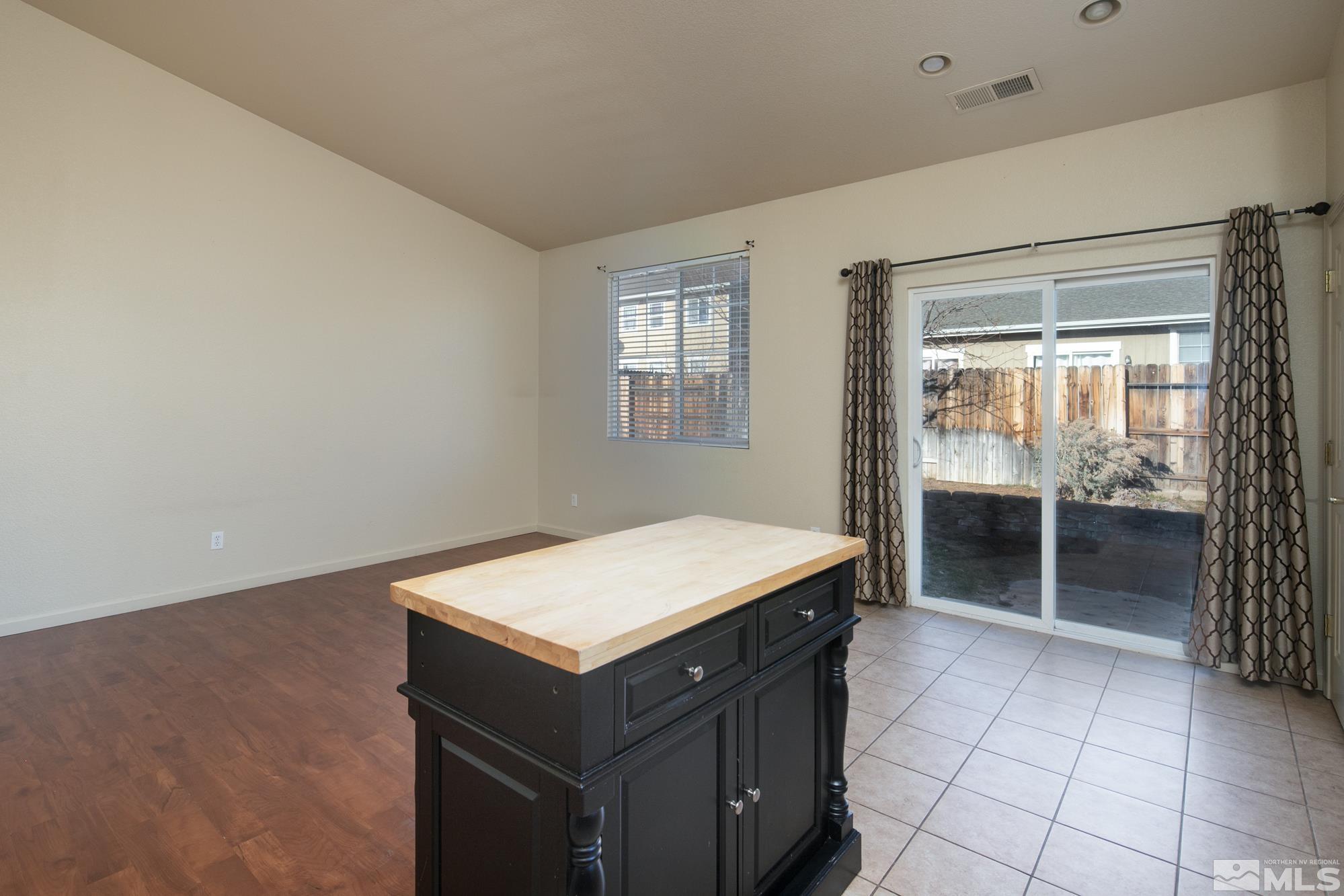 8987 Sorcha Street Reno, NV 89506 - Photo 8 of 29 a kitchen with a wooden cabinets and sink