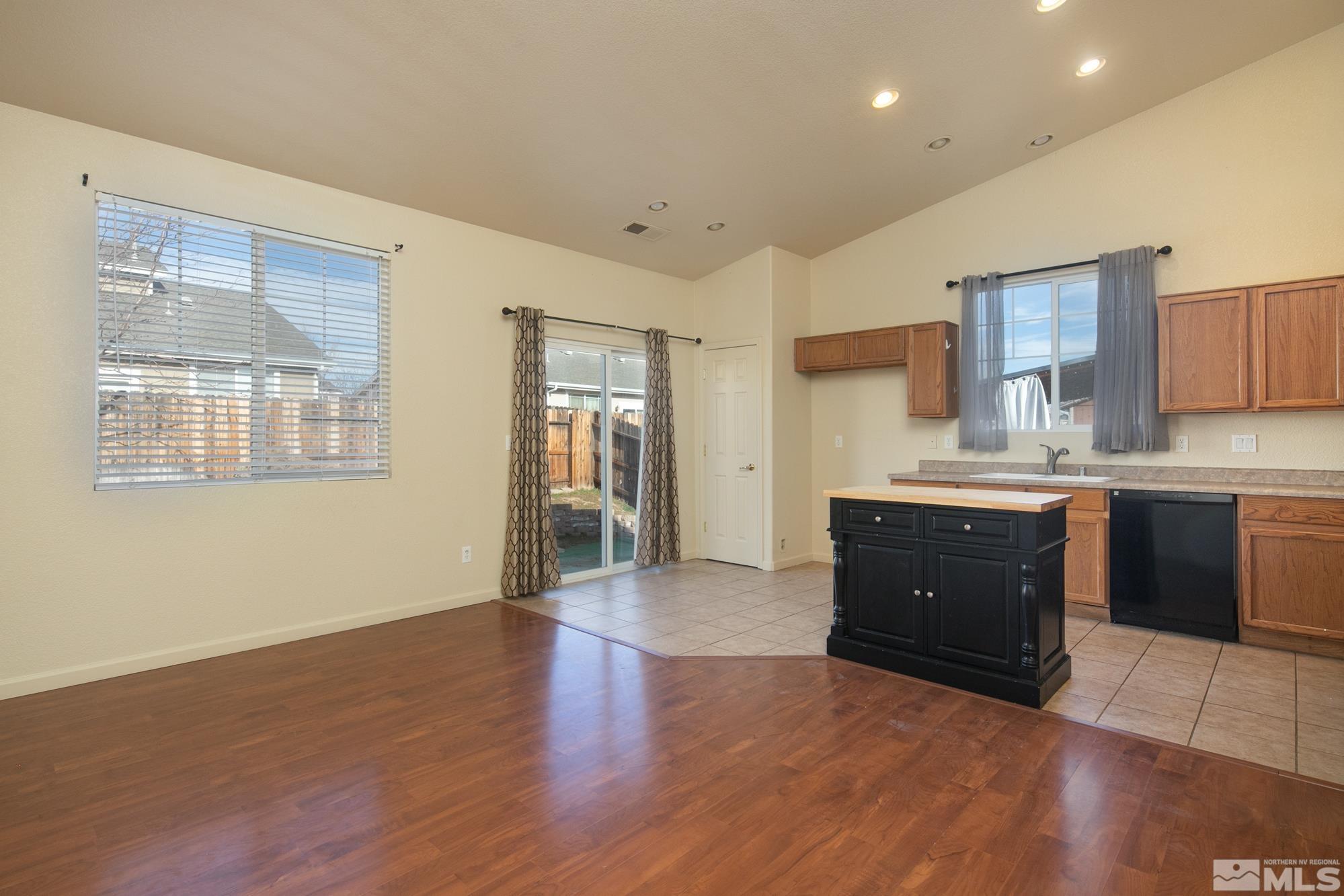 8987 Sorcha Street Reno, NV 89506 - Photo 10 of 29 a large kitchen with stainless steel appliances granite countertop a stove a sink and a refrigerator