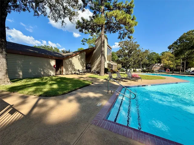 a view of a backyard with swimming pool