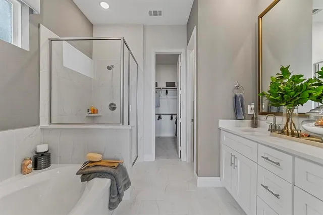 a bathroom with cabinets and shower