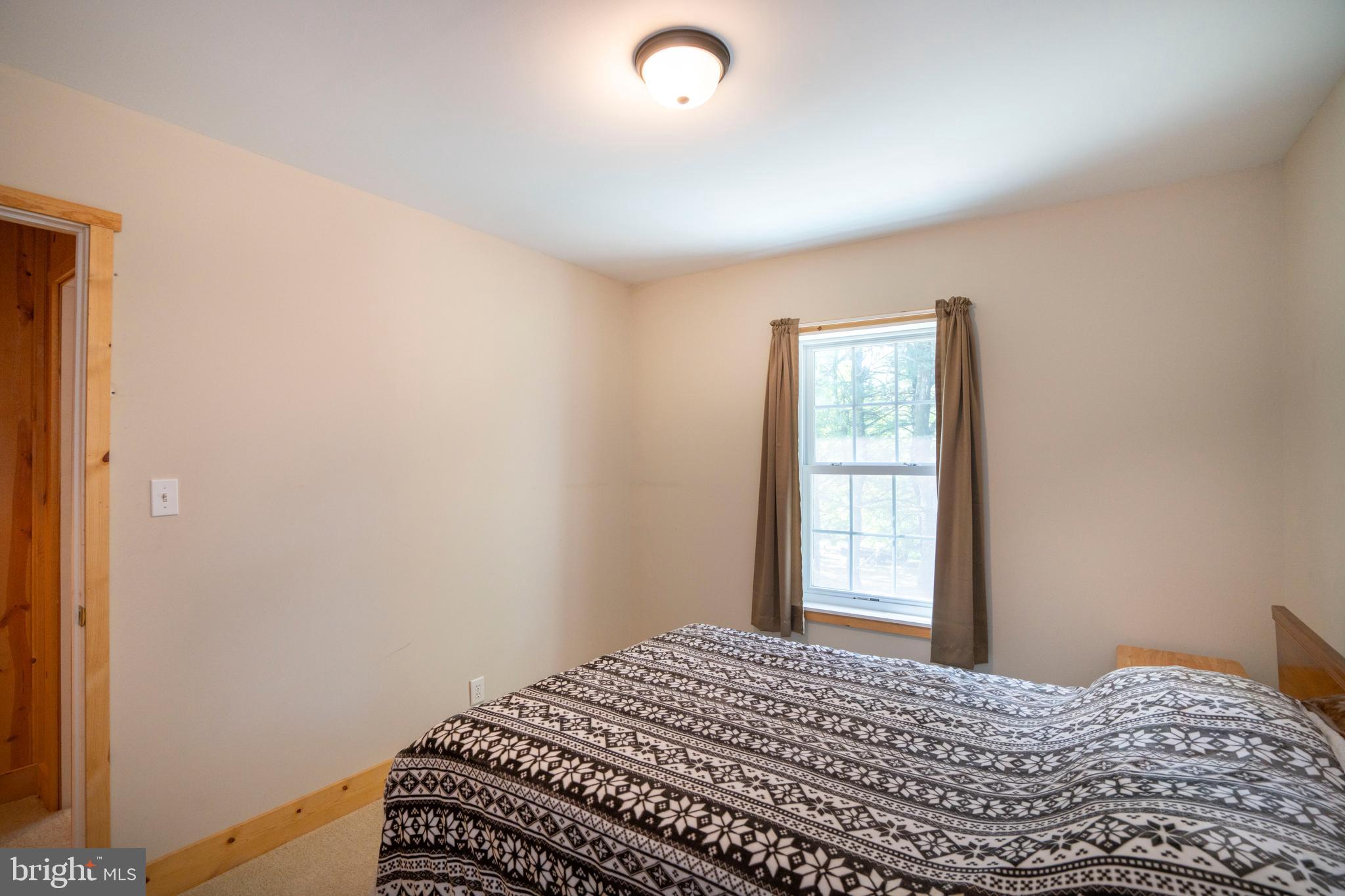 385 Elk Creek Road Aaronsburg, PA 16820 - Photo 51 of 71 a bedroom with a bed and a window