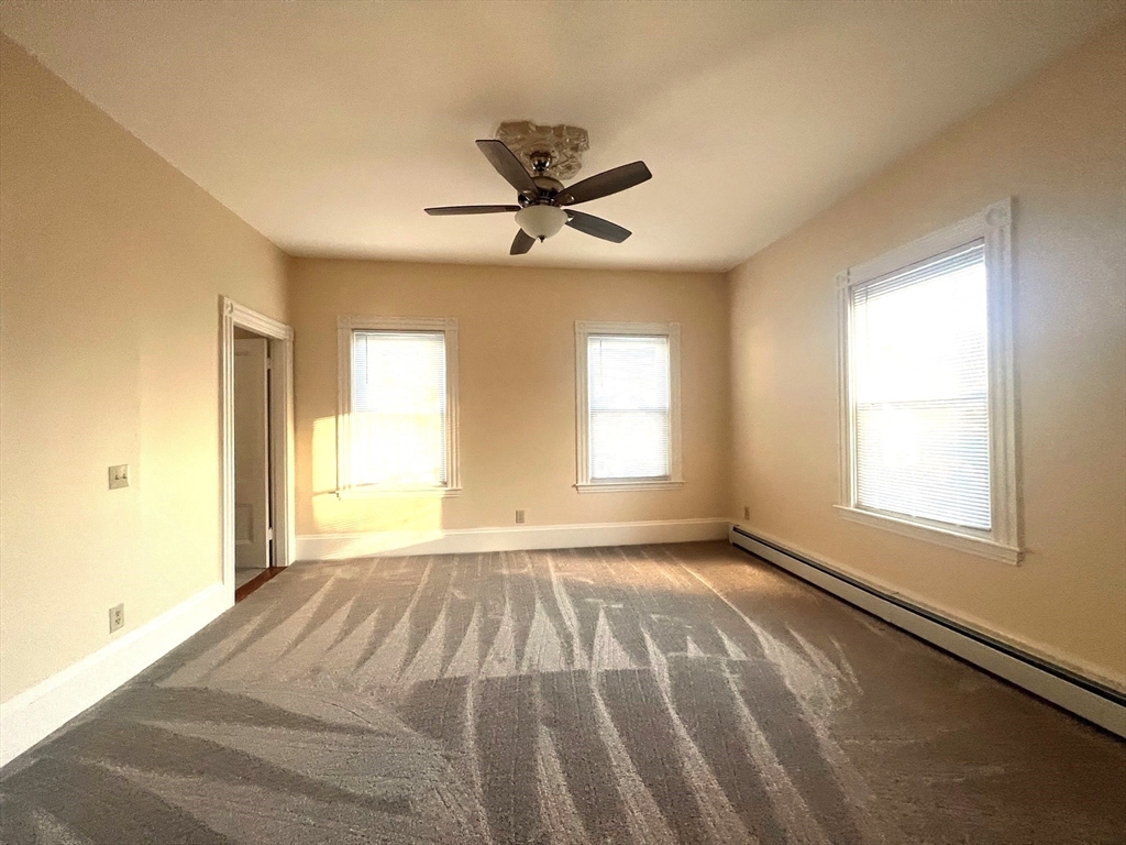 12 Myrtle Street, Unit 2 Middleboro, MA 02346 - Photo 11 of 14 a view of a livingroom with a window and a ceiling fan