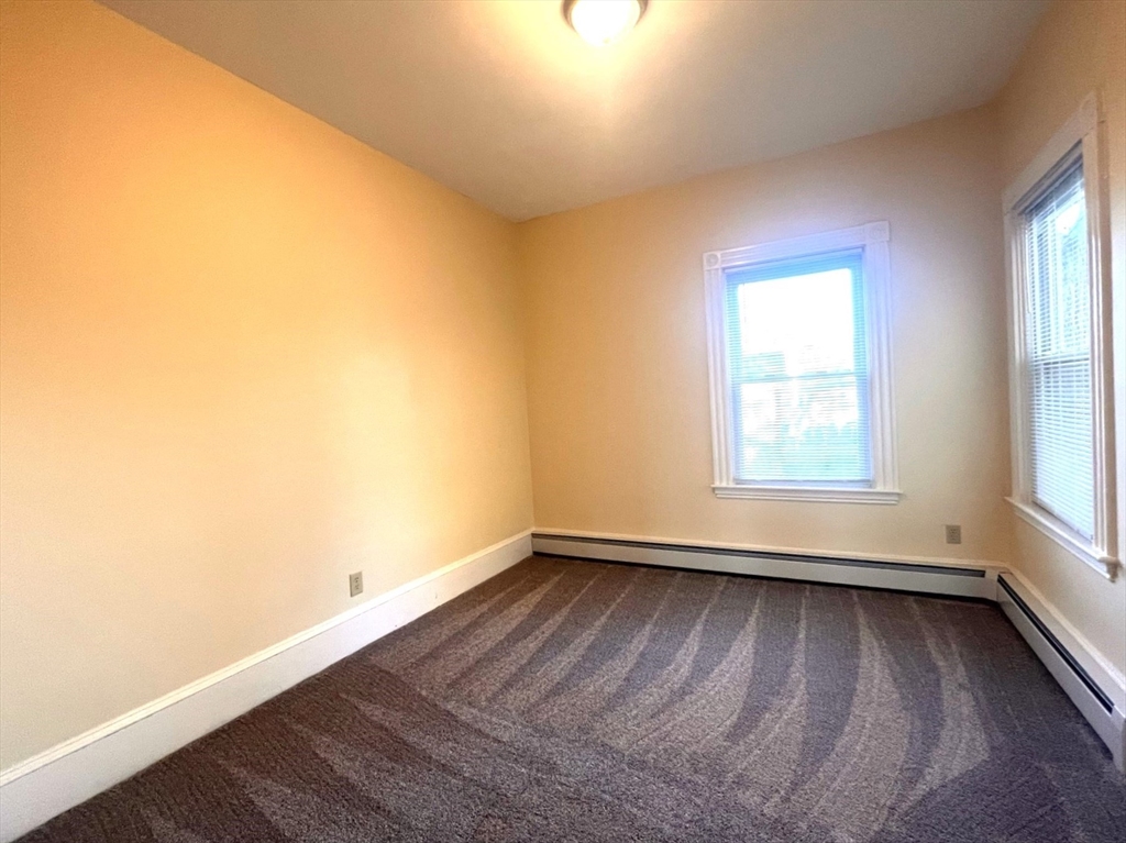 12 Myrtle Street, Unit 2 Middleboro, MA 02346 - Photo 12 of 14 an empty room with wooden floor and windows