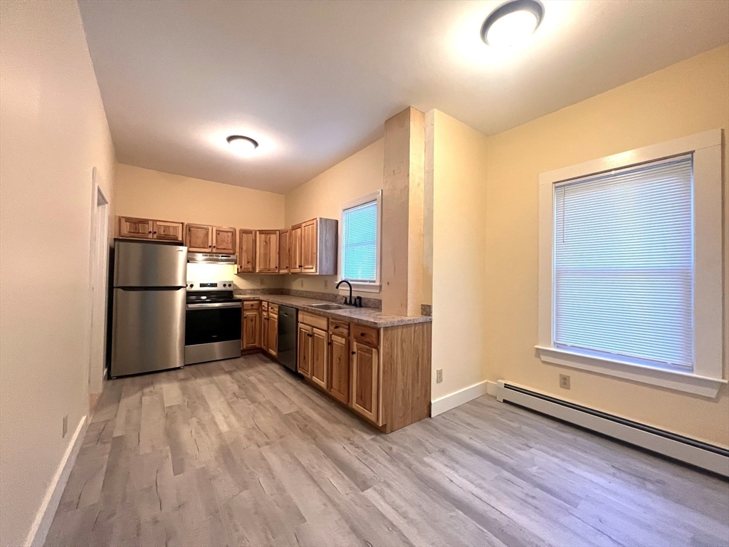 12 Myrtle Street, Unit 2 Middleboro, MA 02346 - Photo 3 of 14 a kitchen with stainless steel appliances a refrigerator and a stove top oven