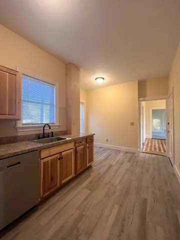 a large kitchen with stainless steel appliances granite countertop a sink and cabinets