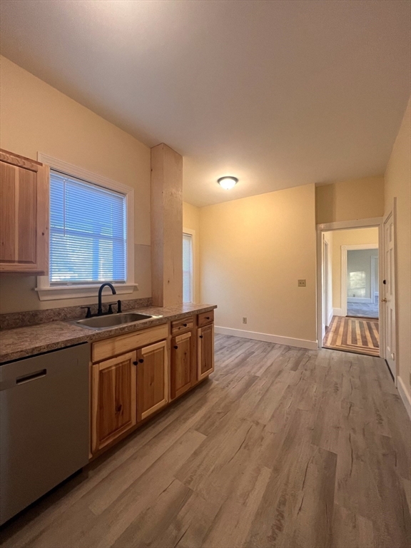 12 Myrtle Street, Unit 2 Middleboro, MA 02346 - Photo 4 of 14 a large kitchen with stainless steel appliances granite countertop a sink and cabinets