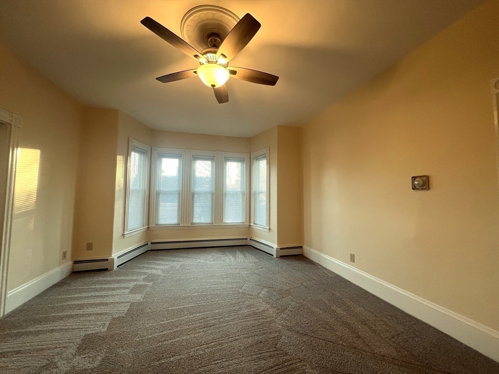 12 Myrtle Street, Unit 2 Middleboro, MA 02346 - Photo 8 of 14 an empty room with wooden floor and windows