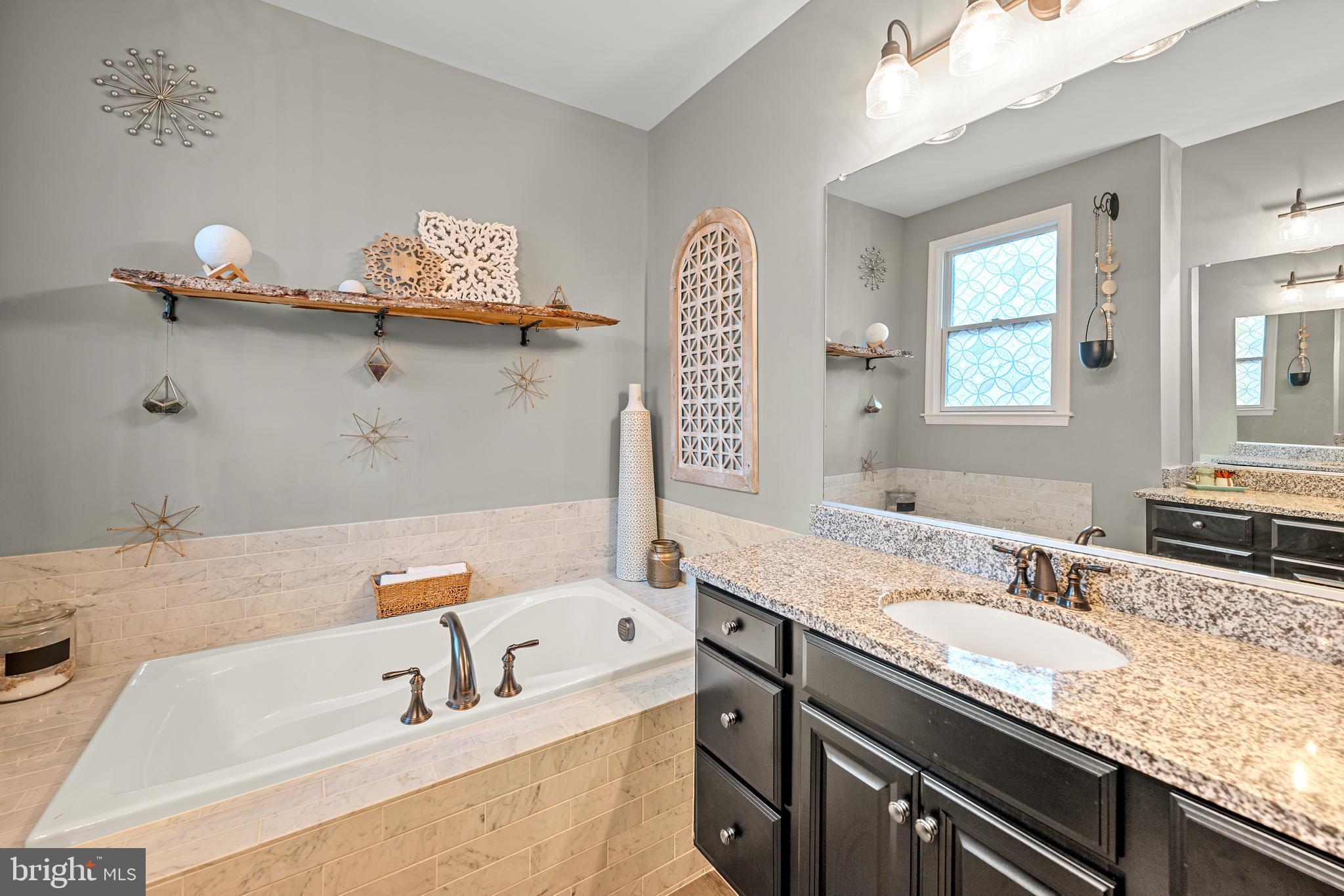 8459 Reformatory Way Lorton, VA 22079 - Photo 31 of 78 a bathroom with a tub sink and mirror