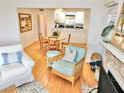 a living room with furniture a flat screen tv and a window