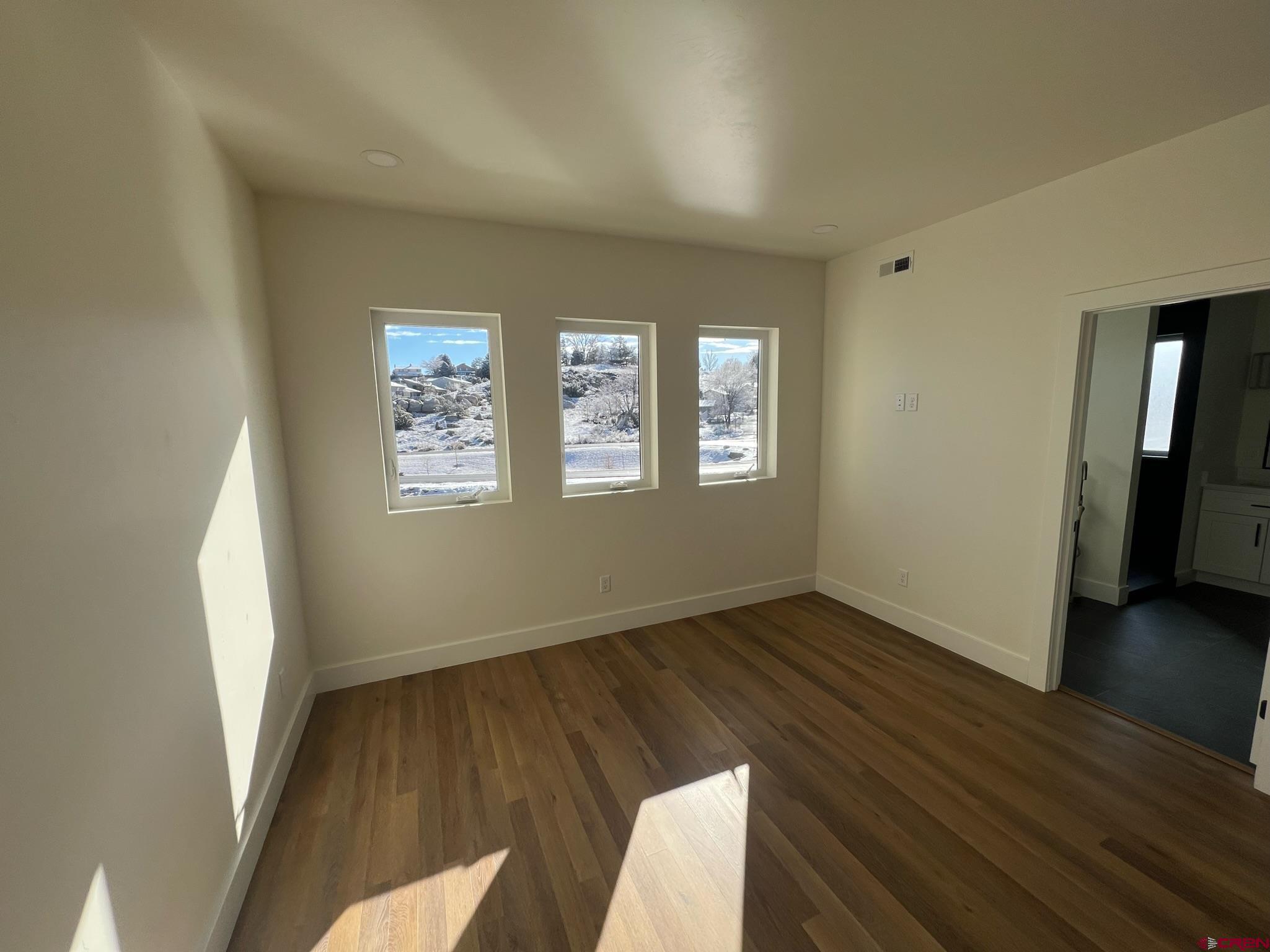 2398 Ridge Cir Drive, Unit B Grand Junction, CO 81507 - Photo 13 of 30 an empty room with wooden floor and windows