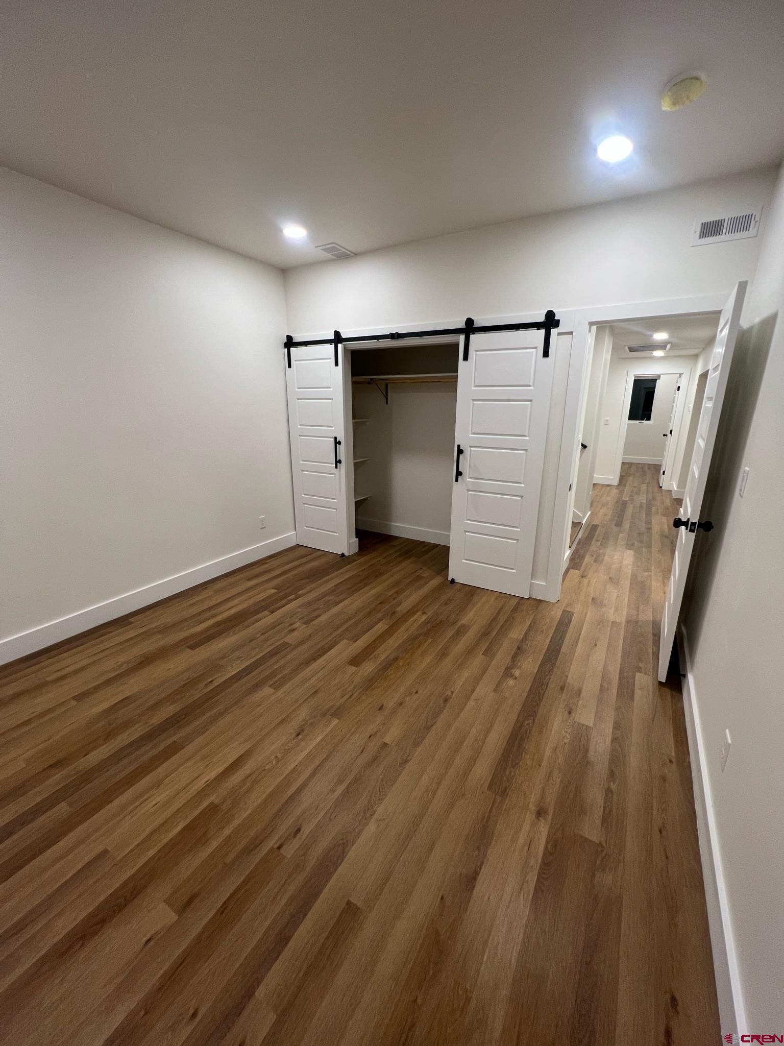 2398 Ridge Cir Drive, Unit B Grand Junction, CO 81507 - Photo 15 of 30 an empty room with wooden floor and entrance