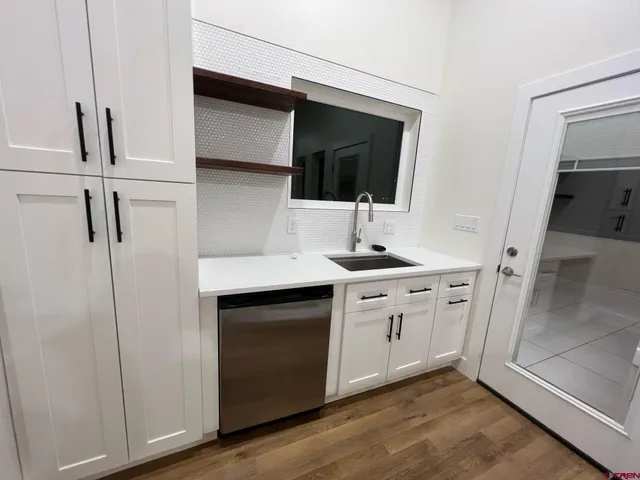 a dining room with furniture and a floor to ceiling window
