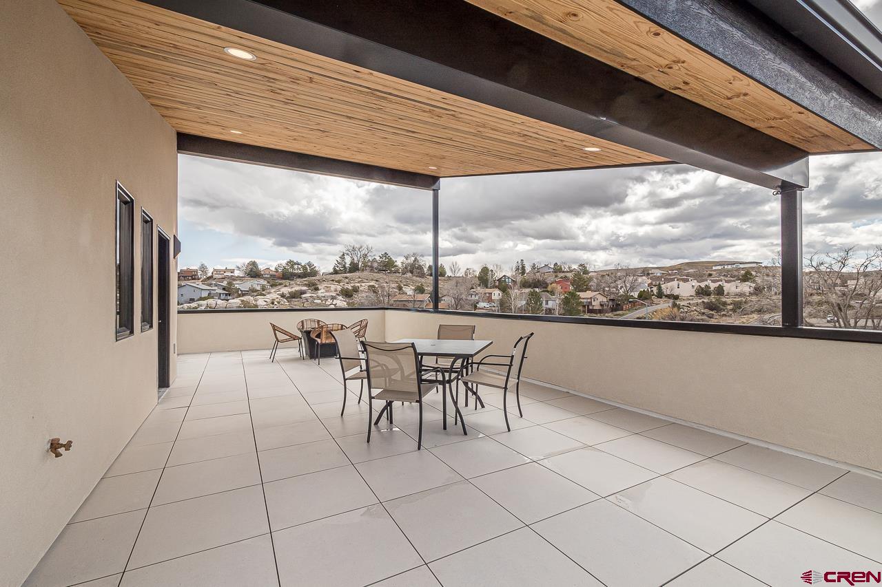 2398 Ridge Cir Drive, Unit B Grand Junction, CO 81507 - Photo 19 of 30 a dining room with furniture and a floor to ceiling window