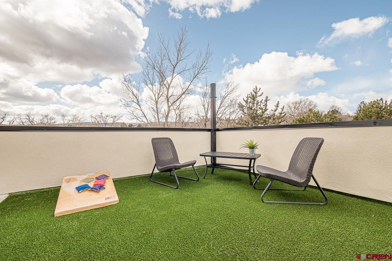 2398 Ridge Cir Drive, Unit B Grand Junction, CO 81507 - Photo 24 of 30 a roof deck with table and chairs