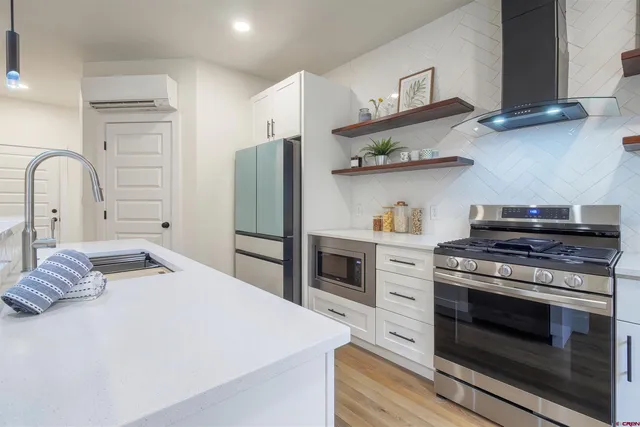 a kitchen with stainless steel appliances a stove and a refrigerator