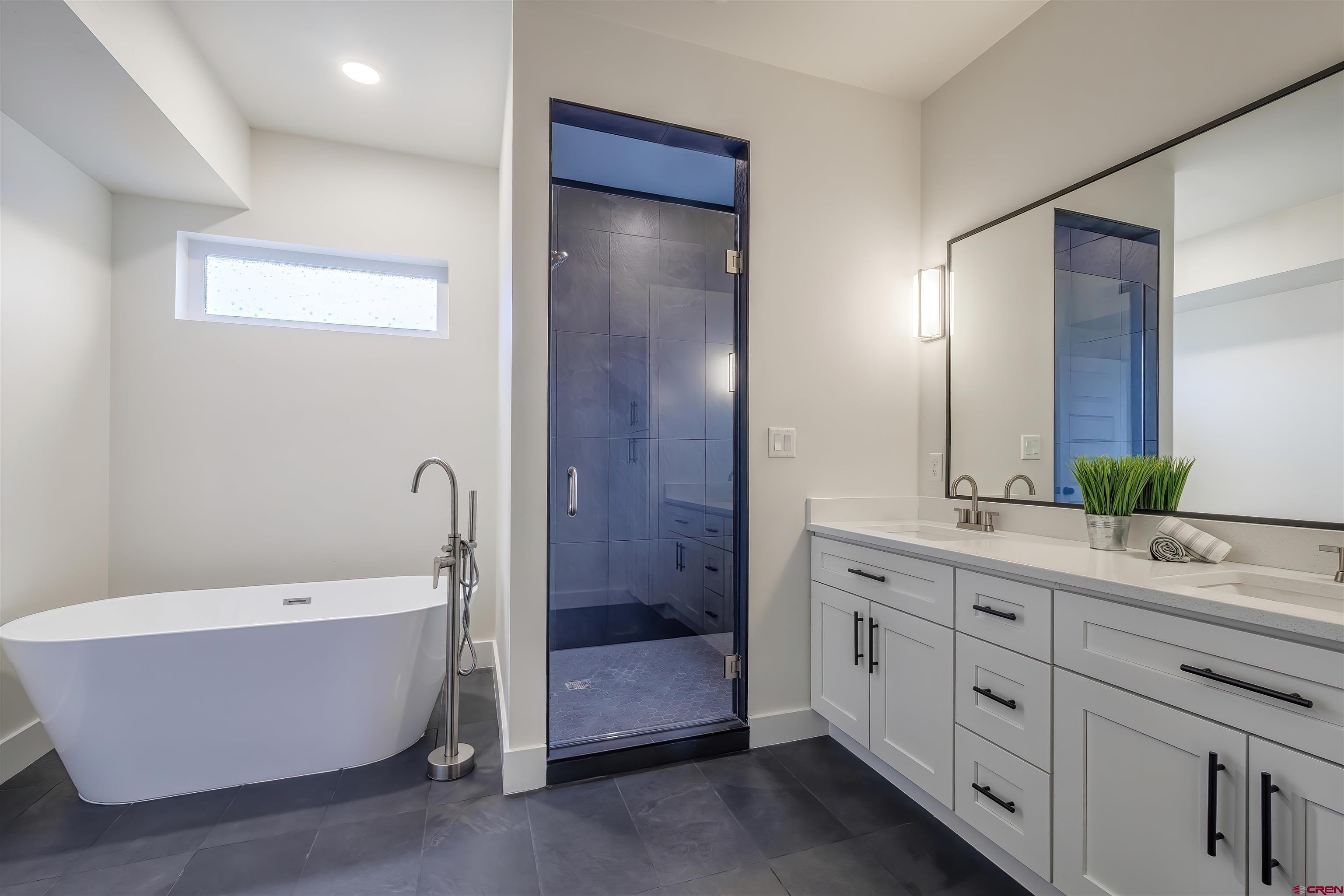 2398 Ridge Cir Drive, Unit B Grand Junction, CO 81507 - Photo 10 of 30 a bathroom with a tub a sink shower and mirror