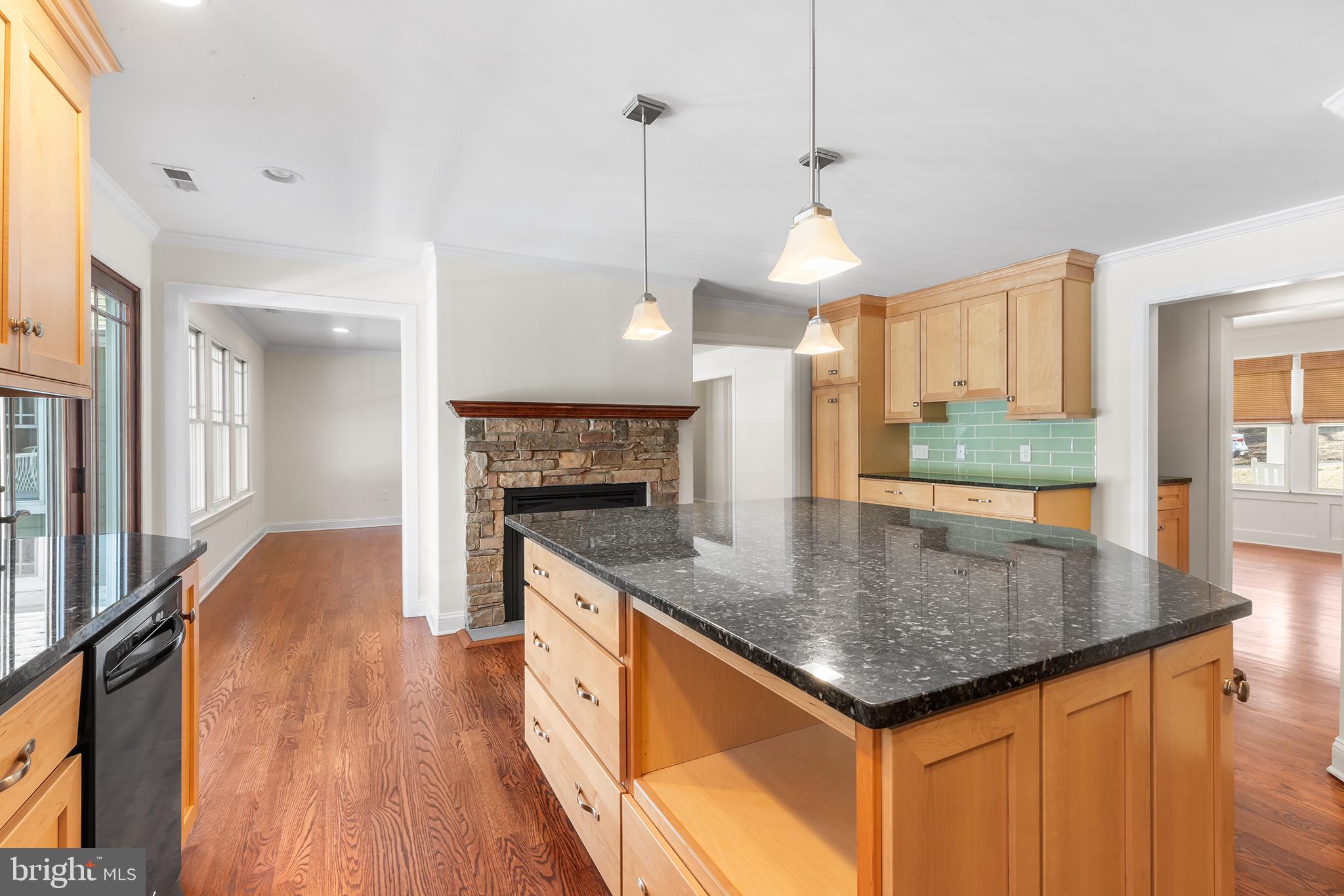 117 Glen Valley Road Yardley, PA 19067 - Photo 12 of 34 a kitchen with a center island wooden floor and a chandelier