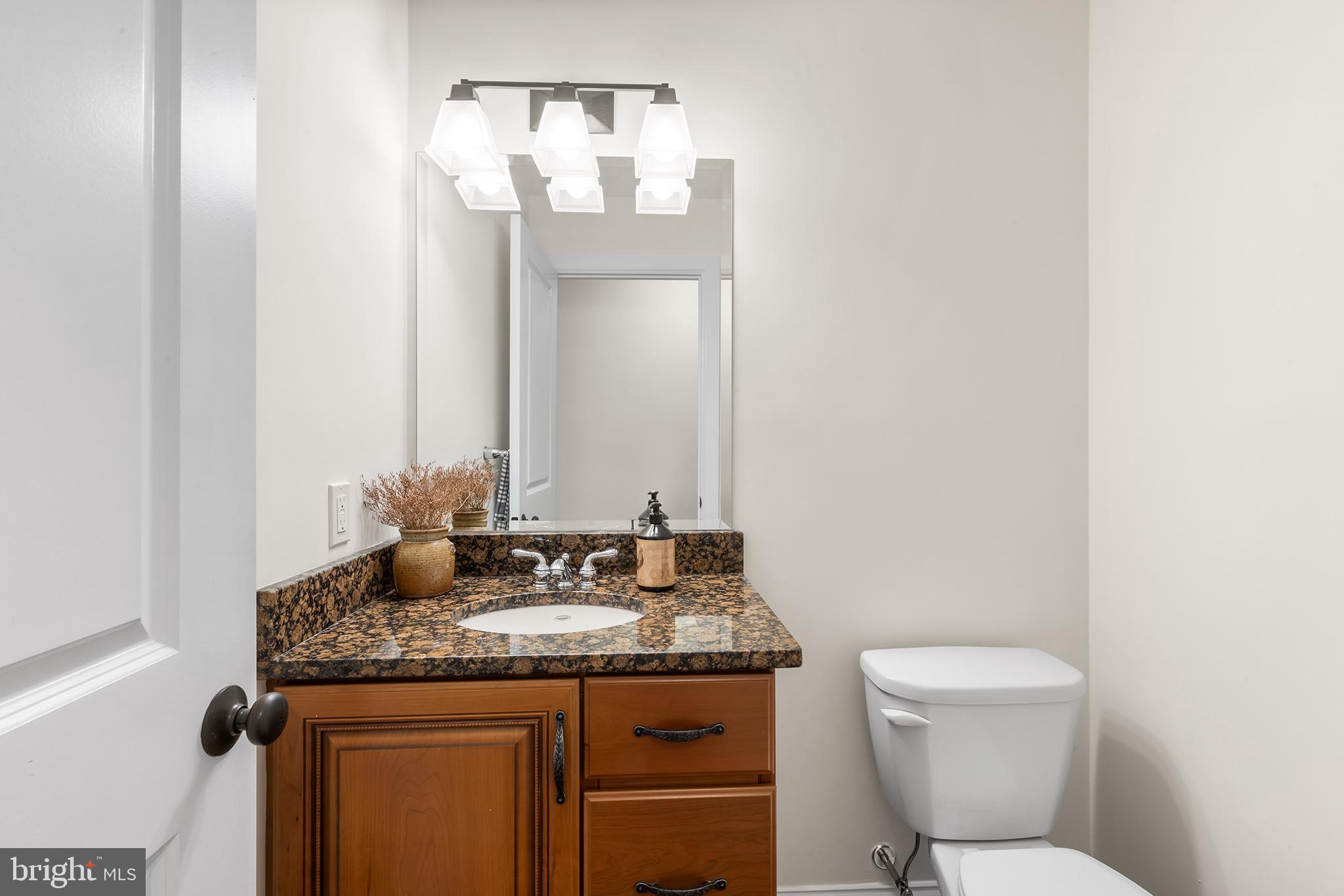 117 Glen Valley Road Yardley, PA 19067 - Photo 14 of 34 a bathroom with a granite countertop toilet sink and mirror