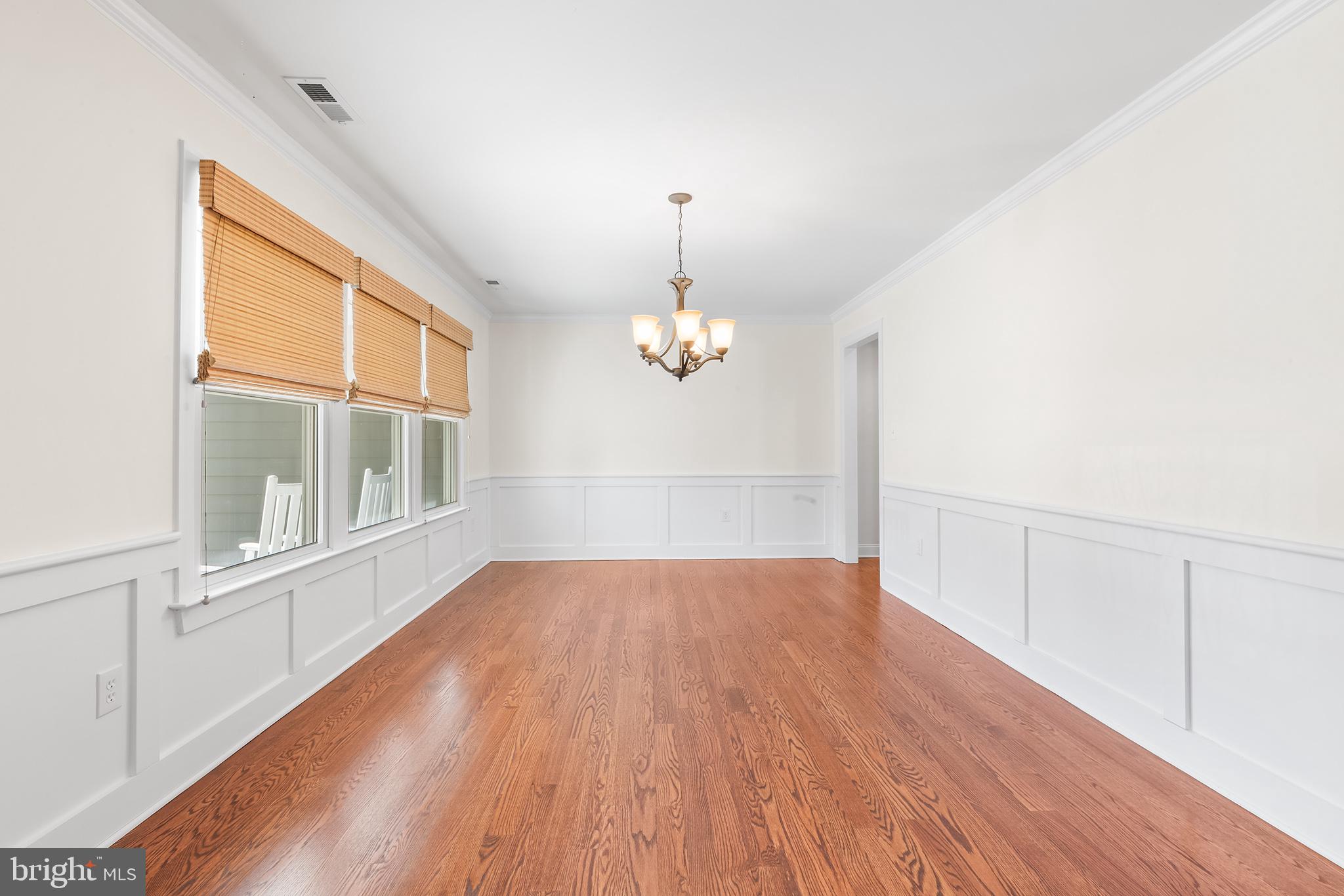117 Glen Valley Road Yardley, PA 19067 - Photo 4 of 34 an empty room with wooden floor cabinet and windows