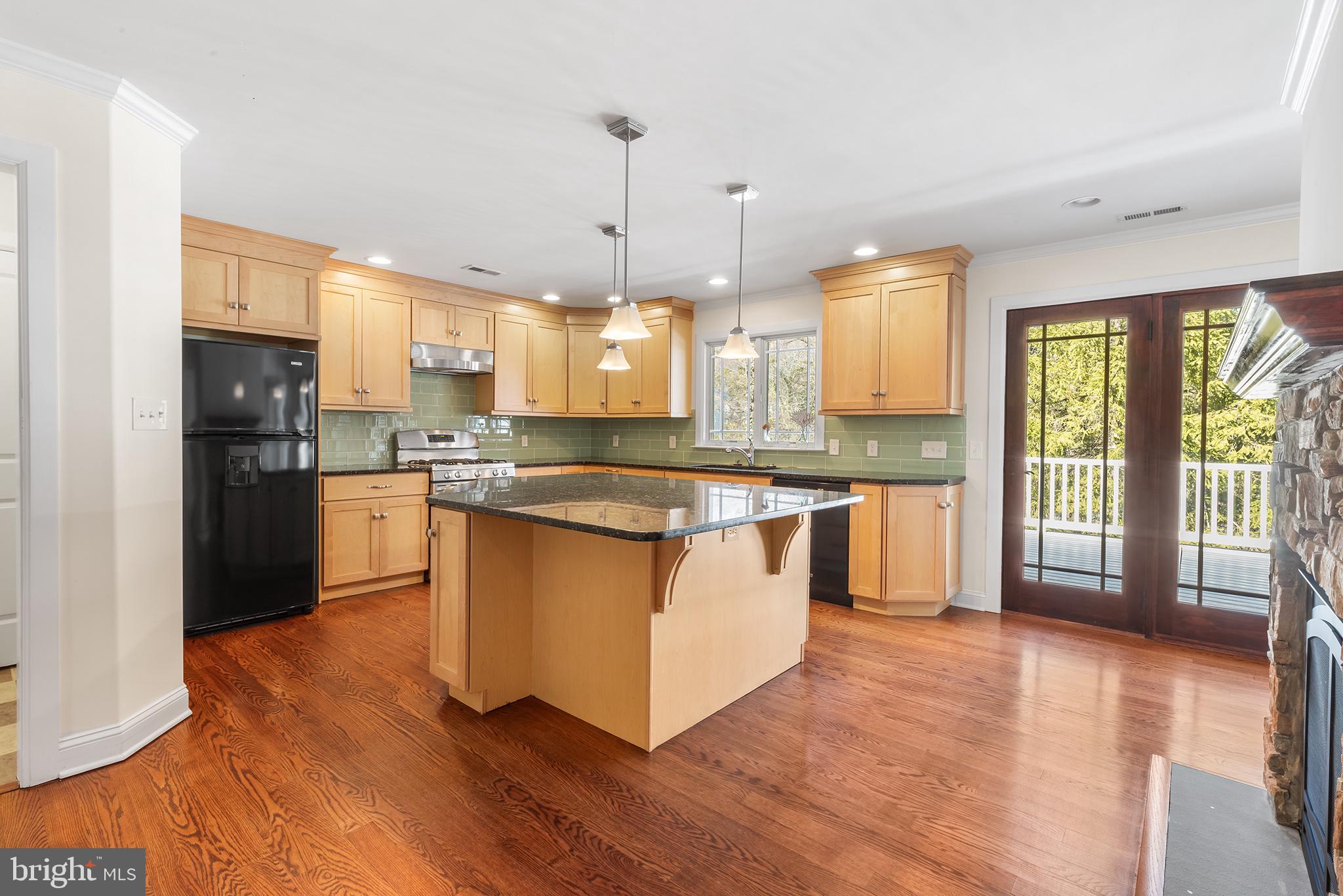117 Glen Valley Road Yardley, PA 19067 - Photo 8 of 34 a kitchen with stainless steel appliances granite countertop wooden floors and white cabinets