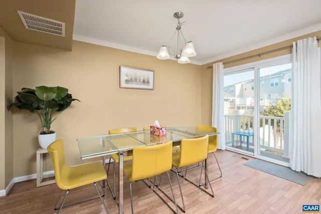 a view of a dining room with furniture wooden floor and chandelier