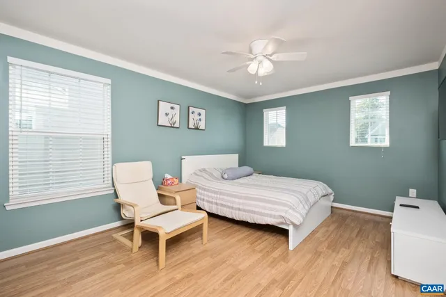 a bedroom with a bed and a chair