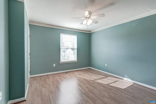 wooden floor in an empty room with a window