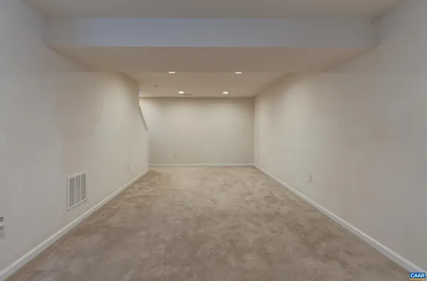 an empty room with a empty space and windows