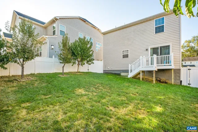 a view of a house with a backyard