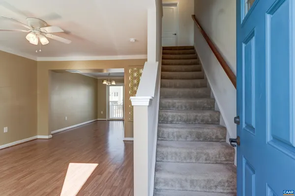 a view of entryway and hall with wooden floor